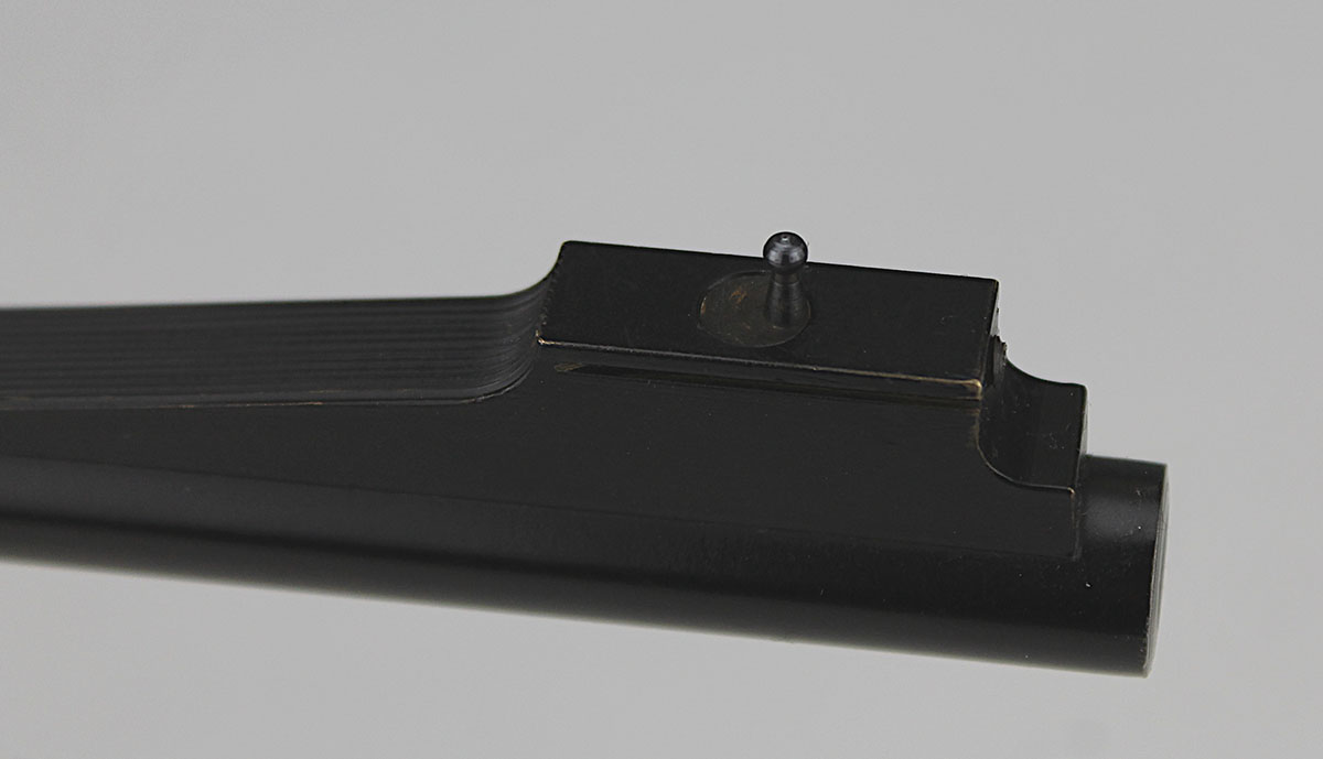 An unusual configuration, the front sight post rotates left and right for windage adjustment.